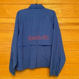 Vintage Reebok 90s spellout logo blue hooded anorak windbreaker